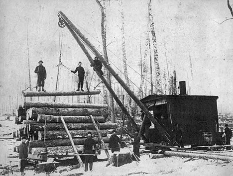 Loading logs on sled with a steam loader, Nixon camp near Akeley, 1904