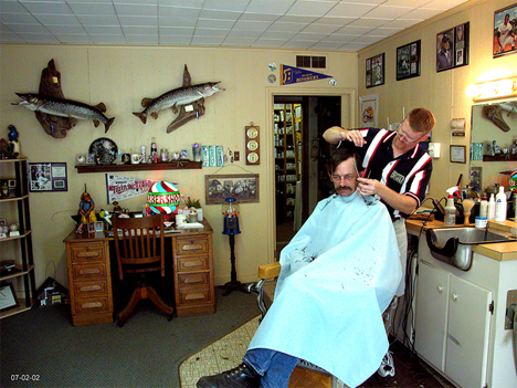 erry Turnquist, mayor of Braham, cutting hair at his barbershop, Braham Minnesota, 2002