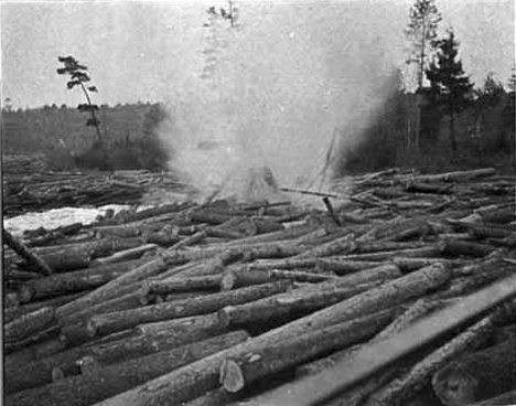 sing explosives to try to break up the log jam on the Big Fork River at Big Falls Minnesota, 1905