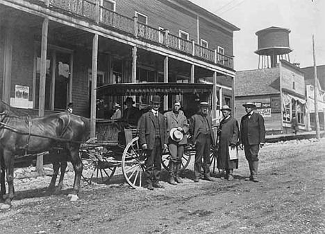 First inspection trip of iron ranges by the Tax Commission; posed in front of Hotel Exchange, Ely; Frank Wildes, Frank McVey, Samuel Lord, O.M. Hall, Richard Hurd, 1907