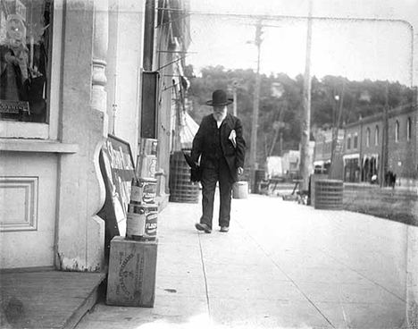 Dr. J. C. Hroslef on sidewalk of Lanesboro business street, Lanesboro Minnesota, 1900's
