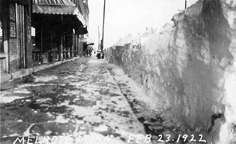 Large snowbank at edge of a sidewalk, Melrose Minnesota, 1922