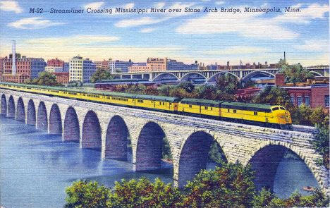 Streamliner Passenger Train crossing Mississippi River over Stone Arch Bridge in Minneapolis Minnesota, 1943