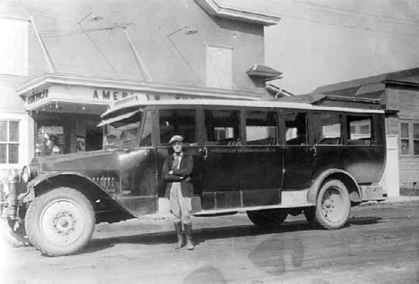 Driver James B. Ryan in front of bus at Mora Minnesota, 1925