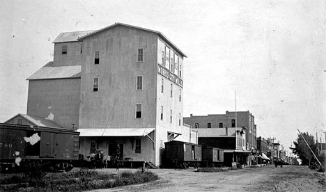 Street scene in Morris Minnesota; Morris City Mills in foreground, 1900