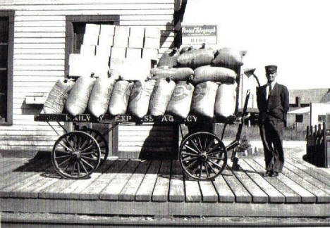 Depot Agent Ed Trombly with shipment of Hicks Wild Rice at Depot, Remer Minnesota, late 1920's or early 1930's