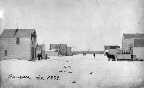 Winter photograph of Roseau in 1893. It is believed to be the first picture taken of Roseau. The winter stage coach is loading people in front of the hotel. O.B. Ekman's Land Office is across the street and Lindberg's store has the side stairs.