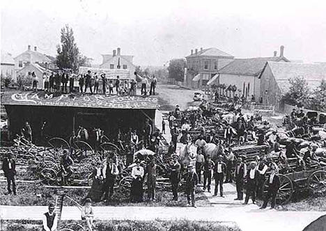 Farm machinery dealers displaying their wares, Rush City Minnesota, 1892