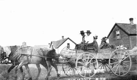 Indians in horse drawn wagon, Sandstone Minnesota, 1910