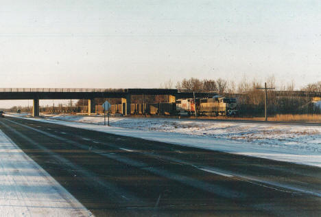 Burlington Northern train along US Highway 10 with Soo Line Trail crossing, Royalton Minnesota, 2003